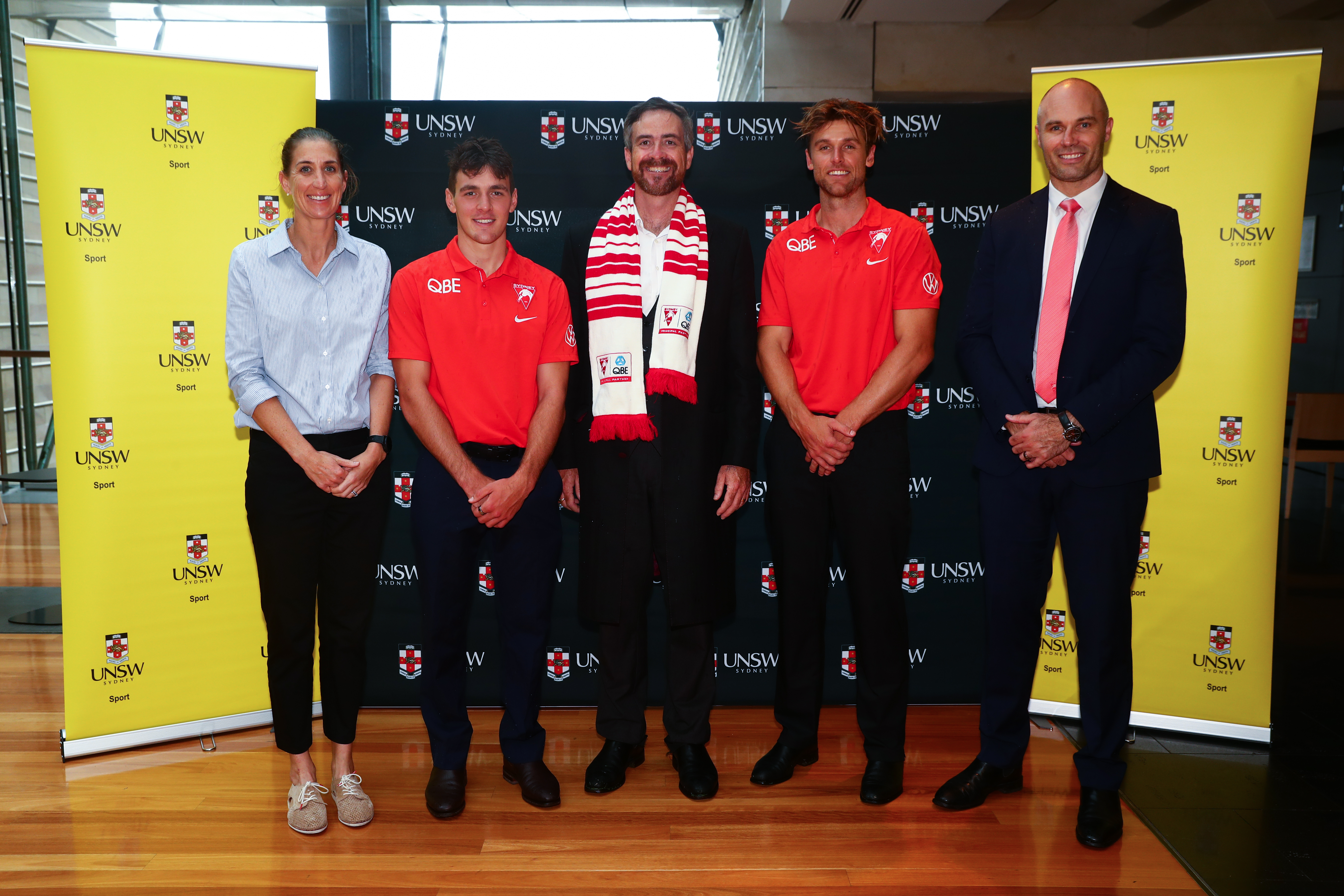Sydney Swans players and staff with UNSW Vice-Chancellor and President Attila Brungs