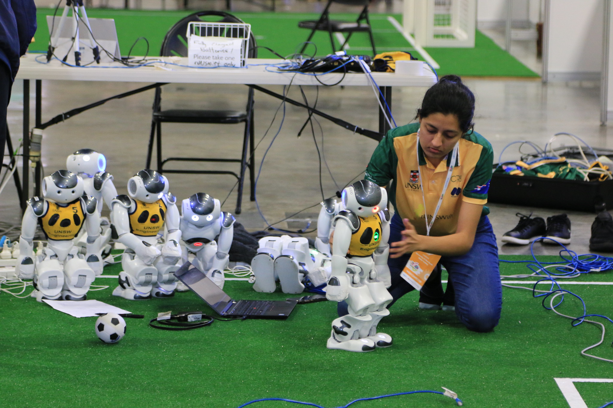 A UNSW team member sets the robots up for competition
