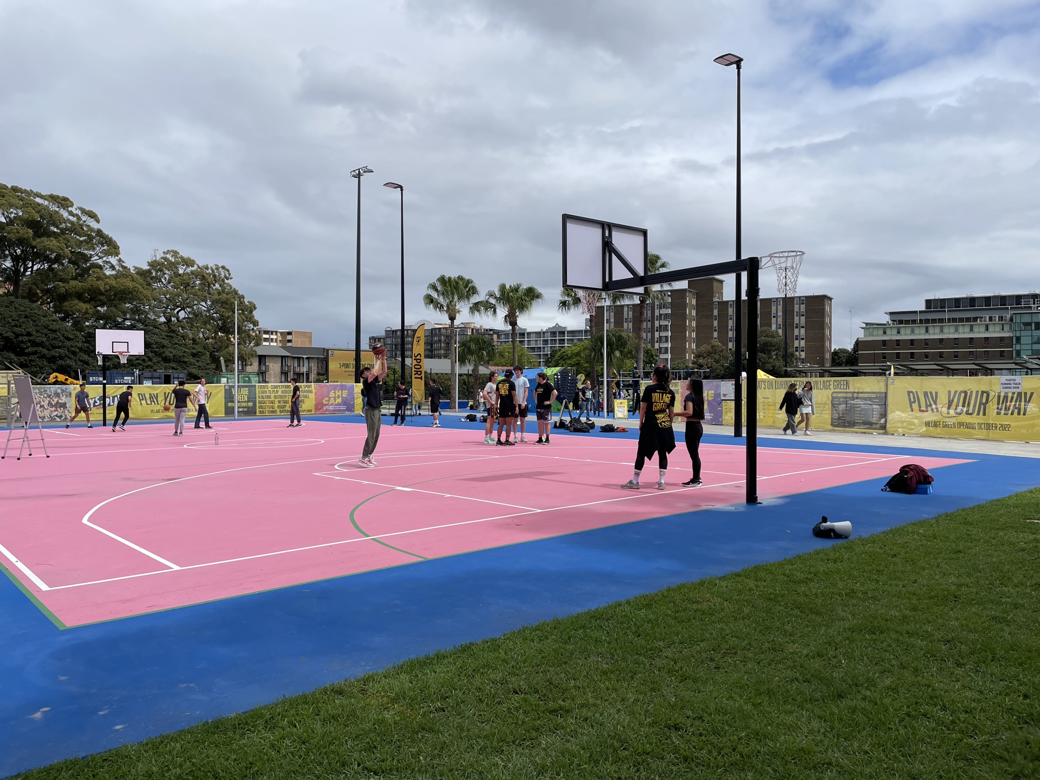 Students playing basketball on one of the new courts