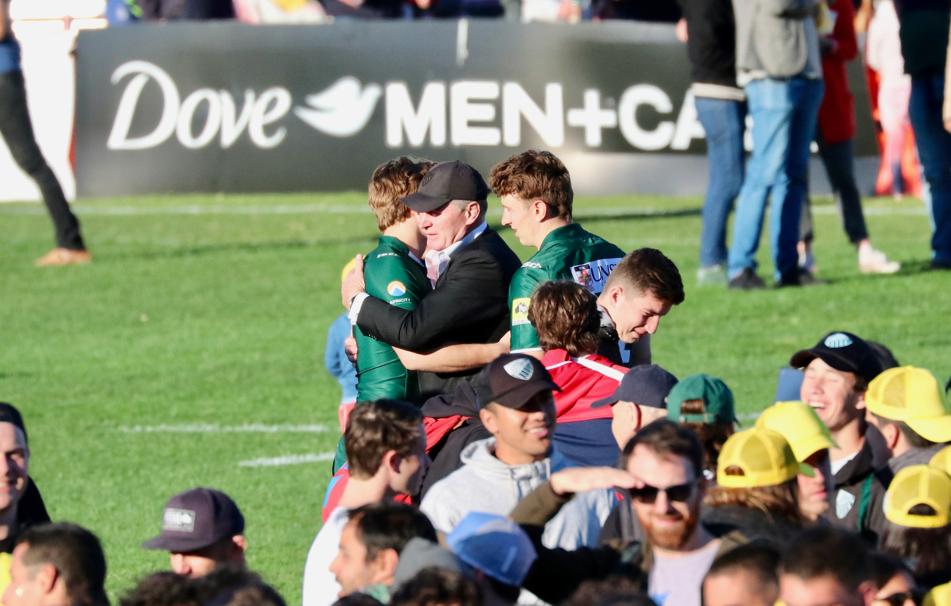 Christian Poidevin embraces father and Wallabies great Simon Poidevin during post-match celebrations.