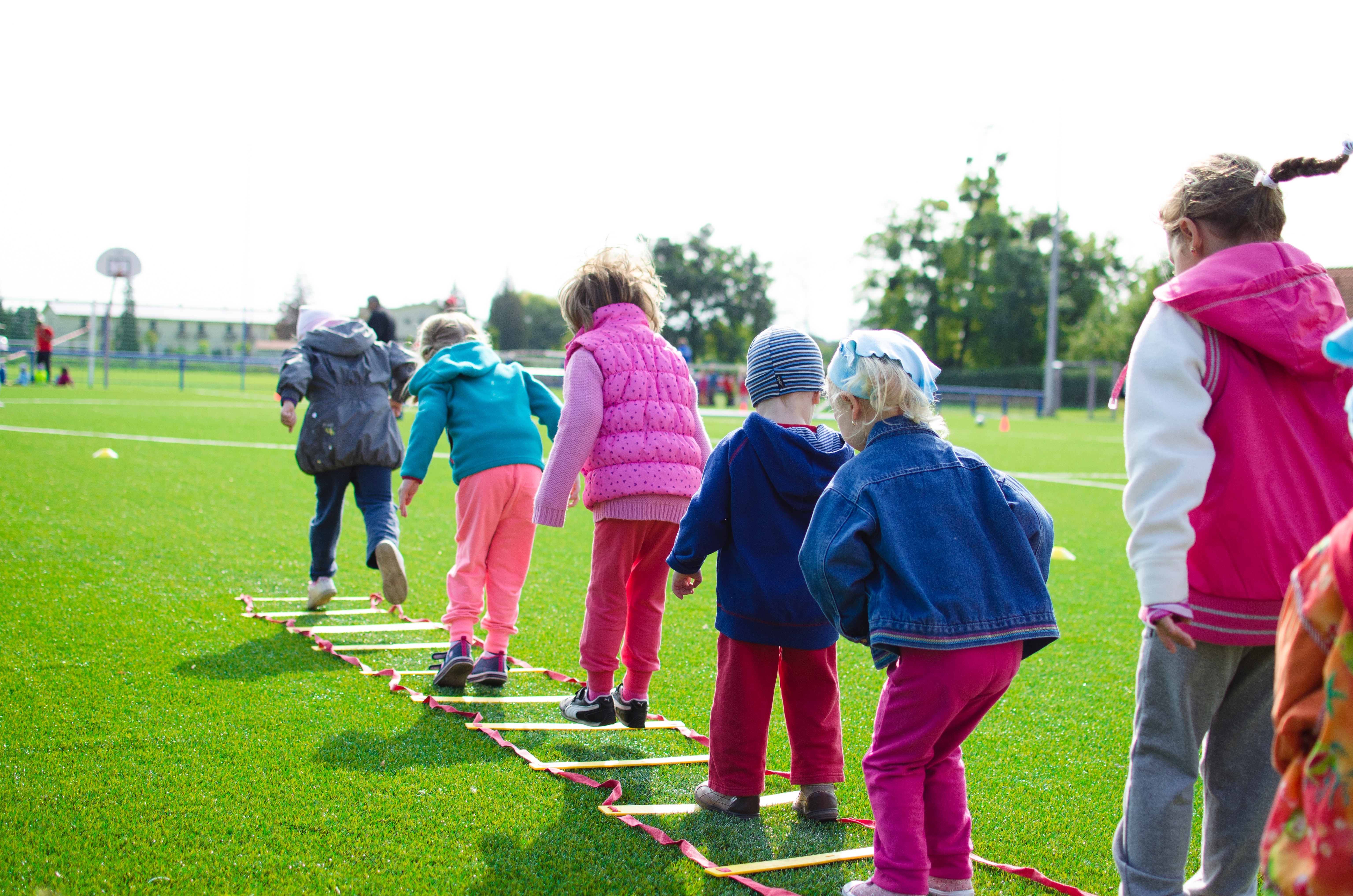Children exercising using agility ladders