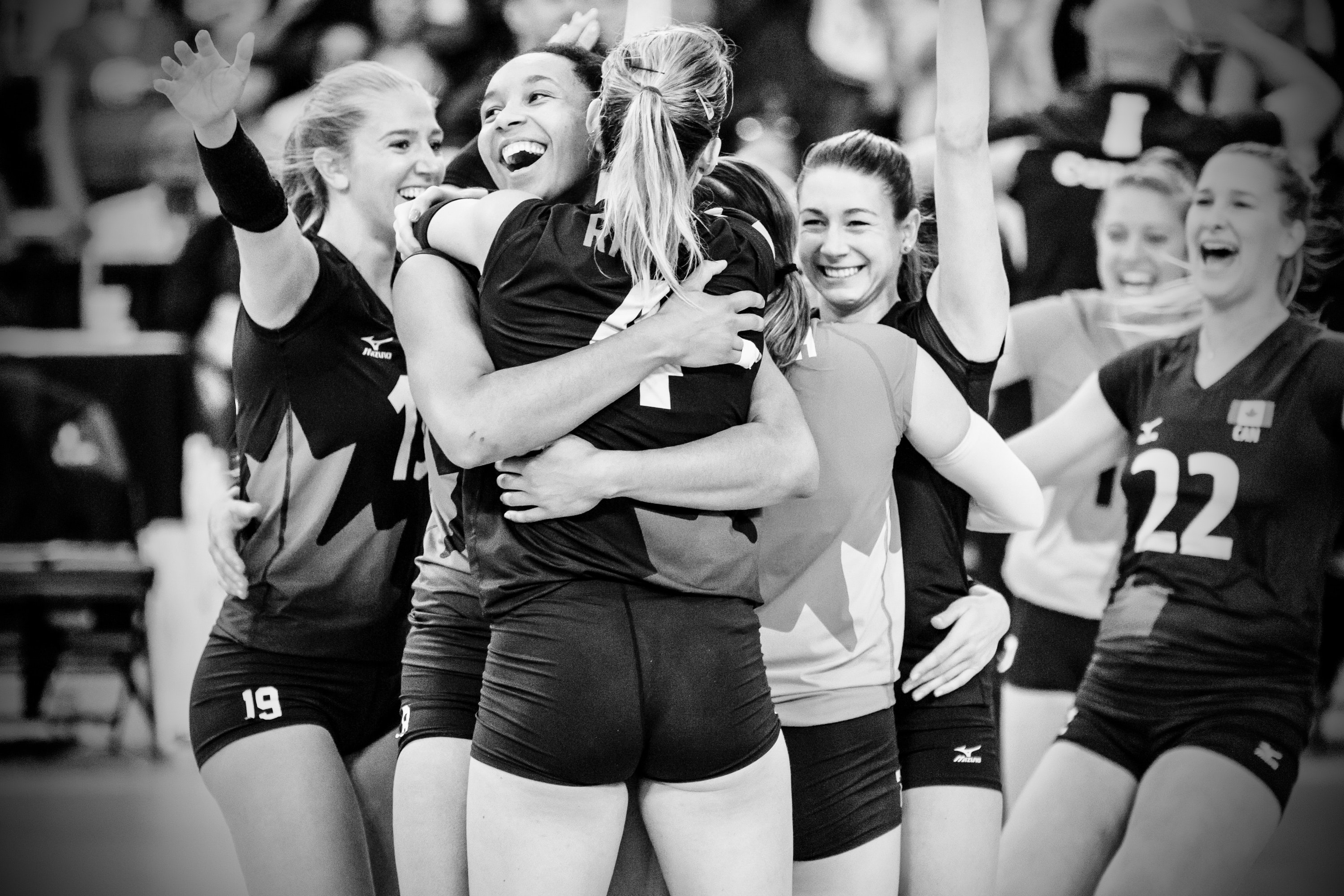 Volleyball players hugging and celebrating