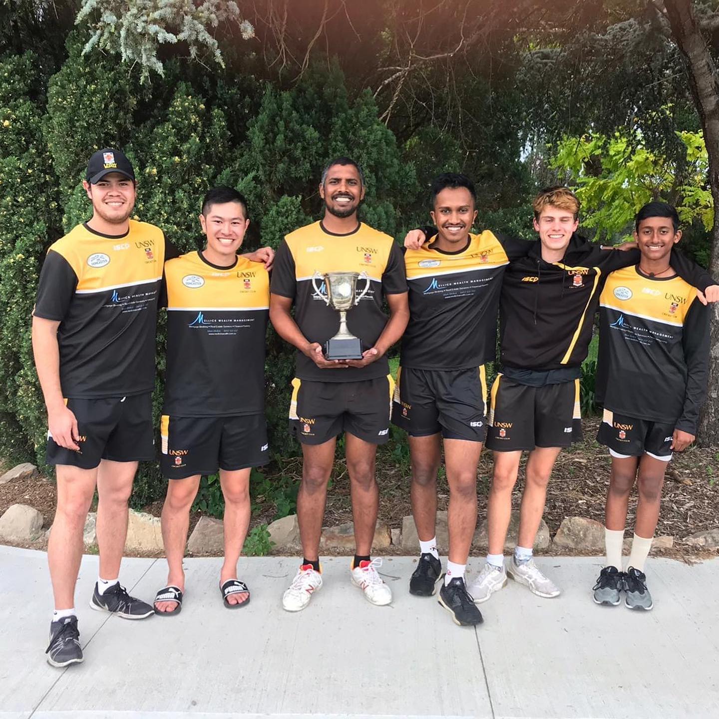 UNSW Cricket Club players with a trophy