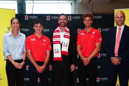 Swans players and staff with UNSW Vice-Chancellor and President Attila Brungs