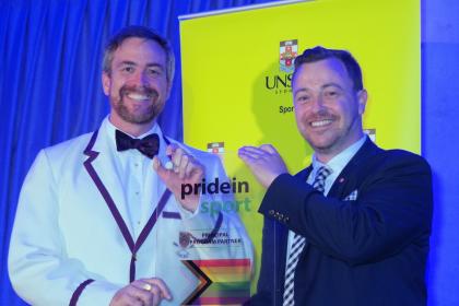 UNSW Vice-Chancellor and President Attila Brungs holds a Pride in Sport plaque with Pride in Sport Project Officer Ben Cork